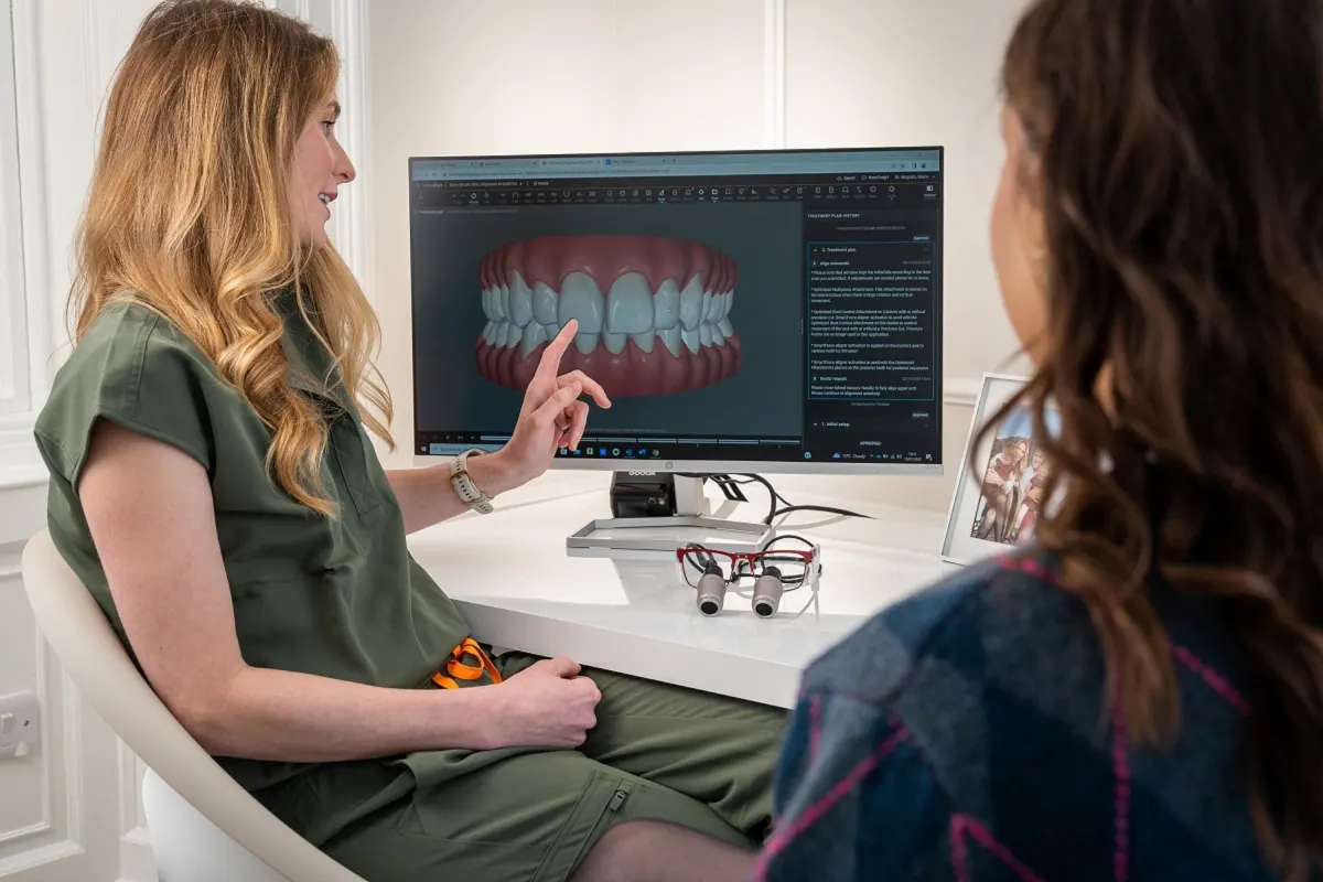 Dentist explaining digital clear aligner treatment planning to a patient