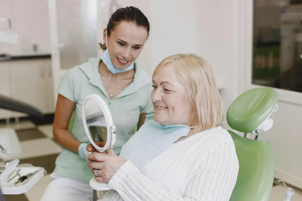 Smiling dental patient reviewing her smile during a clear aligner consultation