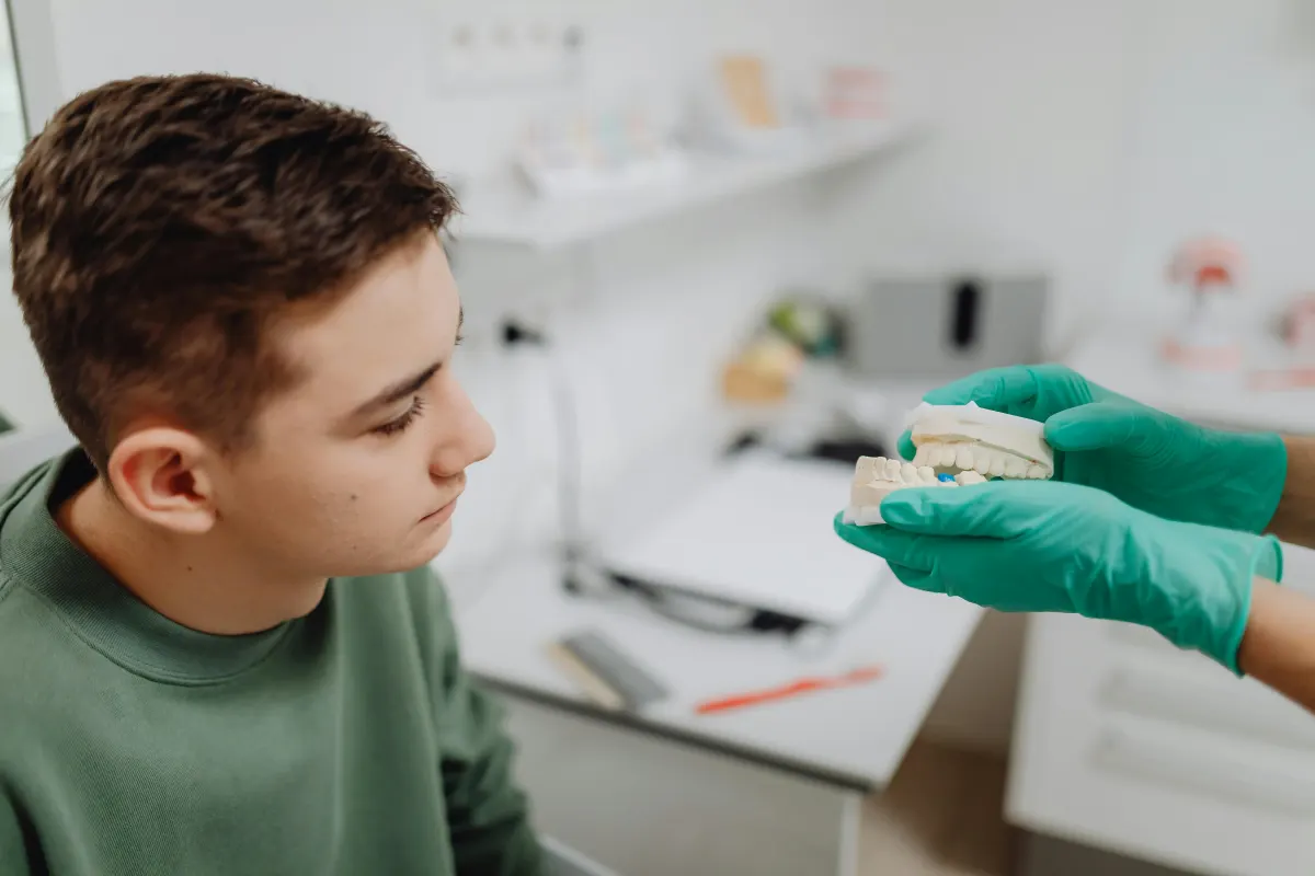 Young patient discussing clear aligner teeth straightening options at a dental clinic